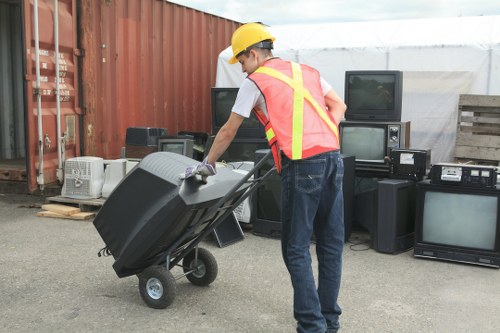 Workers wearing PPE and preparing tools for safe waste removal